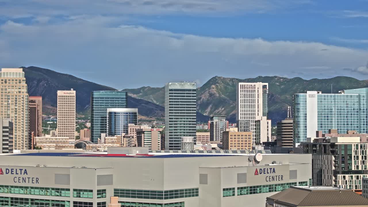Aerial reveal Shot over Apartments Building and Delta Center in Salt Lake City downtown