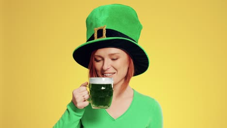 woman with leprechaun's hat drinking beer in the studio shot