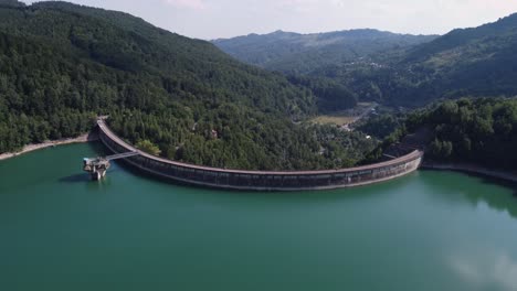 aerial revealing shot of a dam on paltinu lake of doftana valley in romania