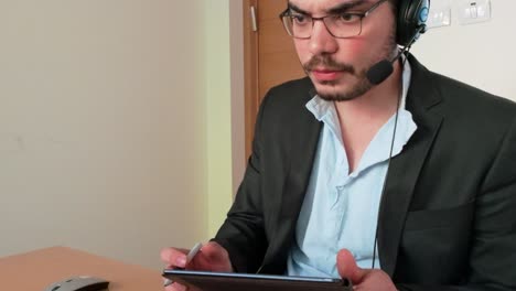 virtual data review: man noting insights on tablet