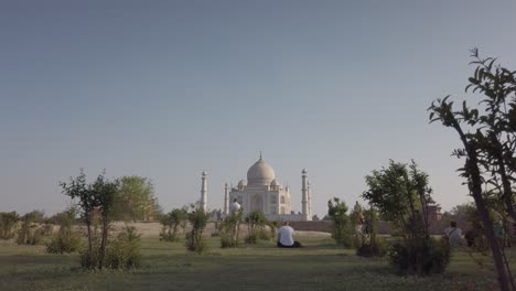 glorious wide shot of taj mahal in mid distance at sunset at agra, agravanam, yamuna river, uttar pradesh, india.