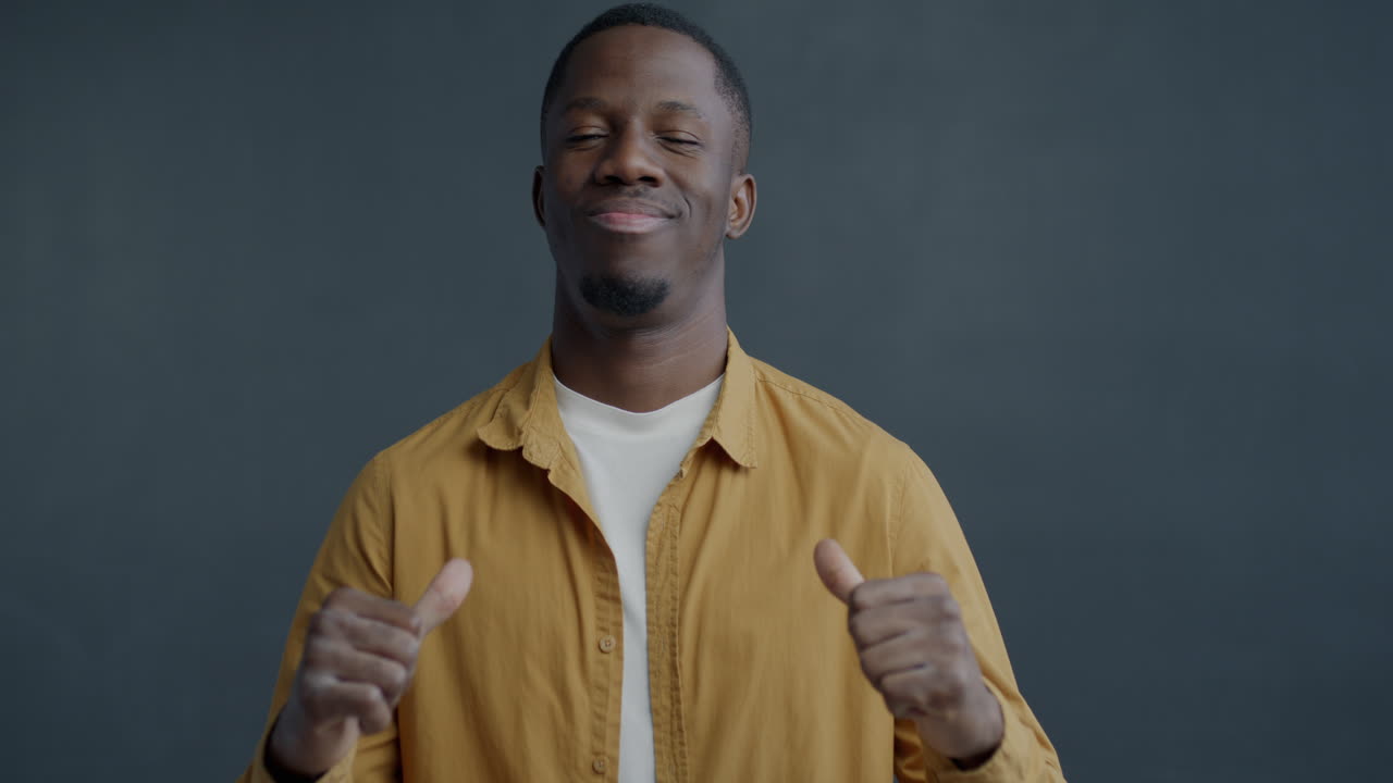 Confident Man Smiling and Pointing