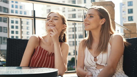 two women having a conversation outdoors at a cafe