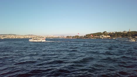 evening, cinematic slow-mo, breathtaking view of sarayburnu from ferry on golden horn in istanbul