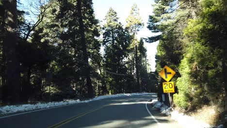 Driving-on-the-road-to-Lake-Arrowhead-some-snow-with-redwood-trees-using-DJI-OSMO-Pocket