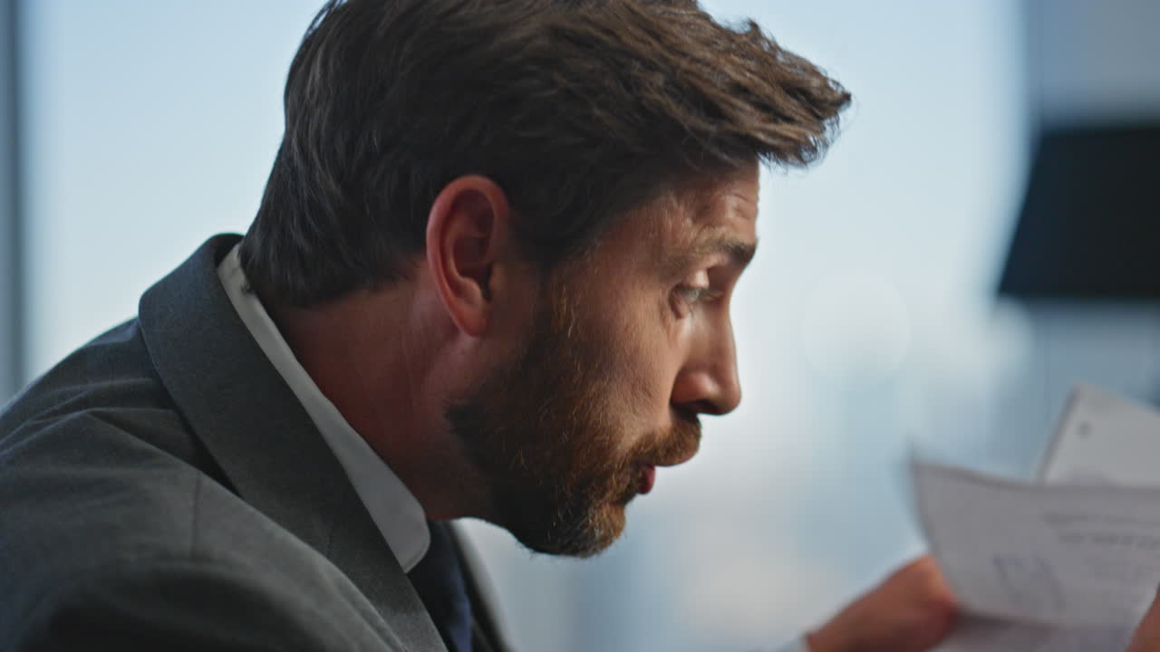 Emotional manager discussing failure holding papers closeup. Angry man arguing