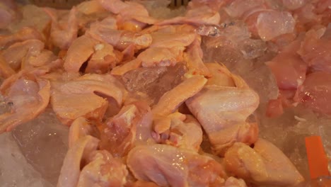 chicken wings on ice at street food market for sale