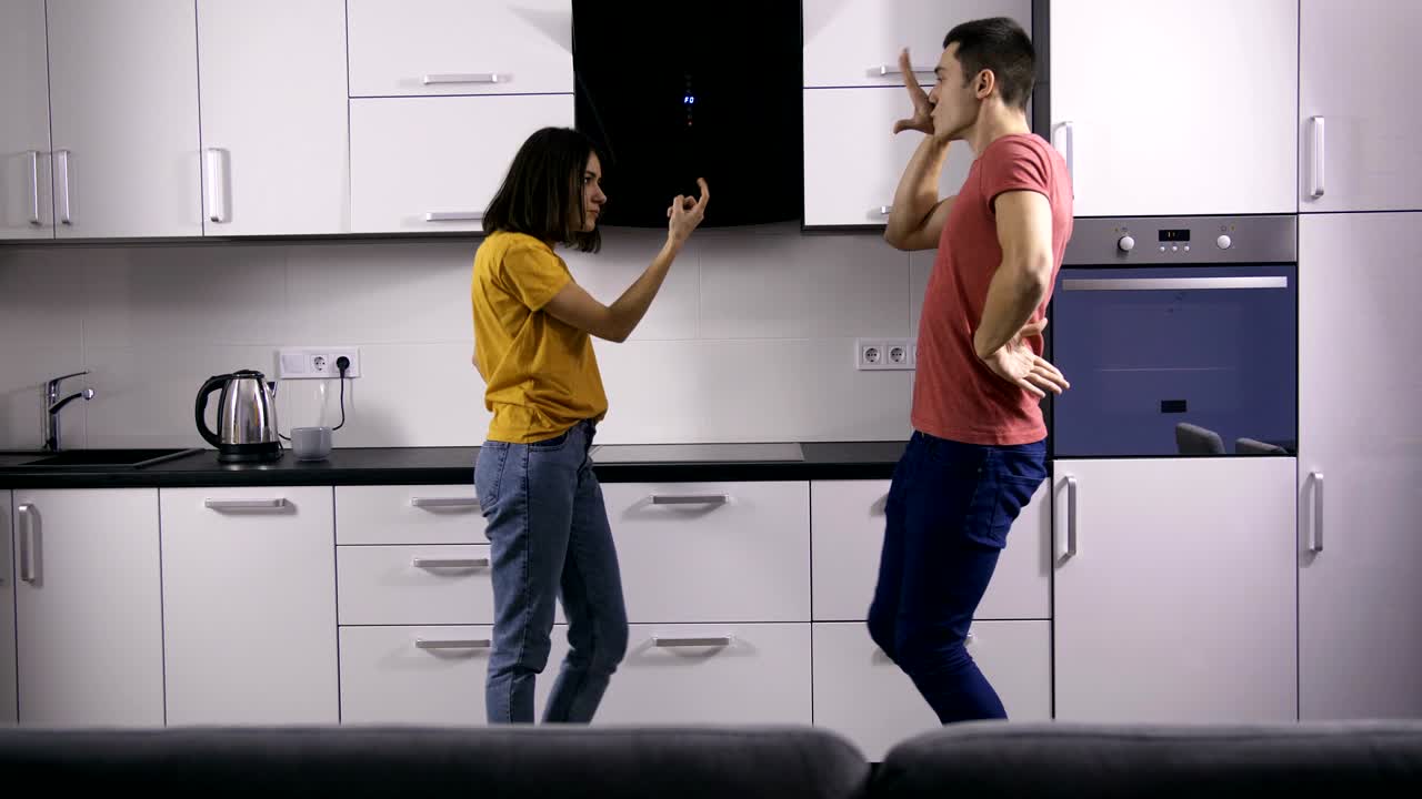 Young creative couple's dance moves in kitchen