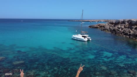 Romantic-Couple-Celebrating-Vacations-on-Paradise-Beach,-Blue-Lagoon-in-Cyprus,-Aerial