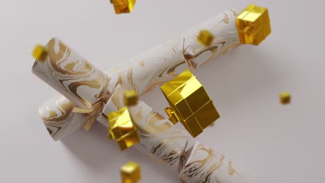 animation of christmas crackers and presents falling on white background