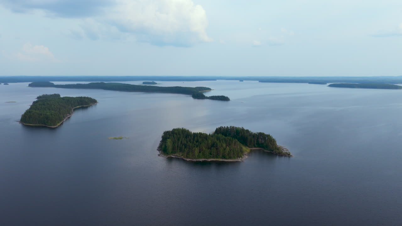 Aerial ascending shot of an island on lake Puruvesi, summer in Saimaa, Finland