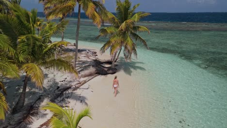 girl waking on a beach in a remote island in kuna yala, panama