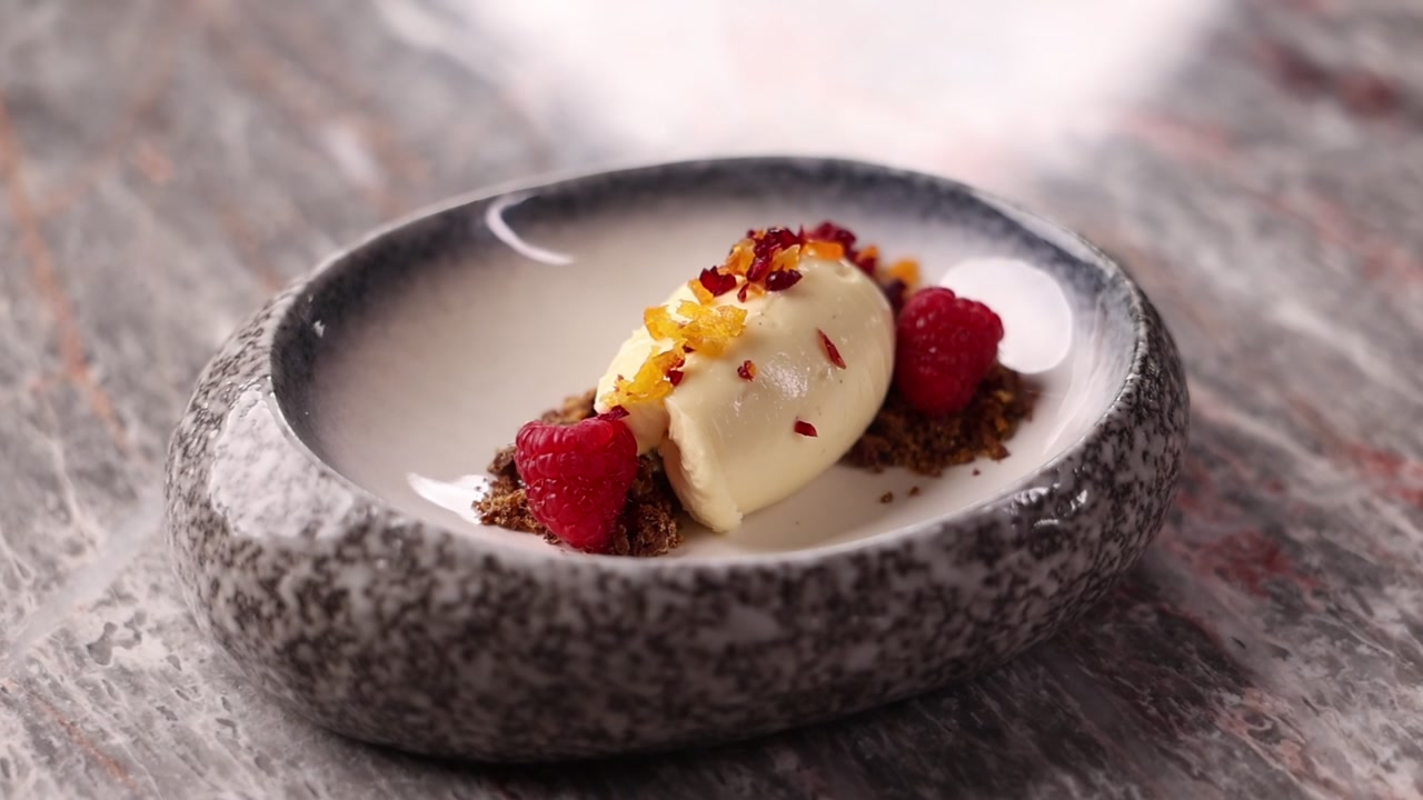 Gourmet Dessert Plating with Ice Cream and Fresh Raspberries