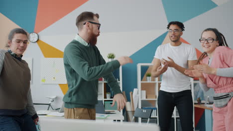 happy team dancing in the office
