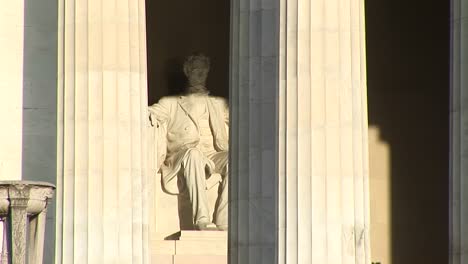 closeup of lincoln memorial in washington dc shows statue of president abraham lincoln behind classic greek columns