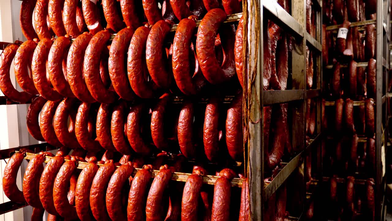Smoked Sausages Hanging on Racks in a Factory