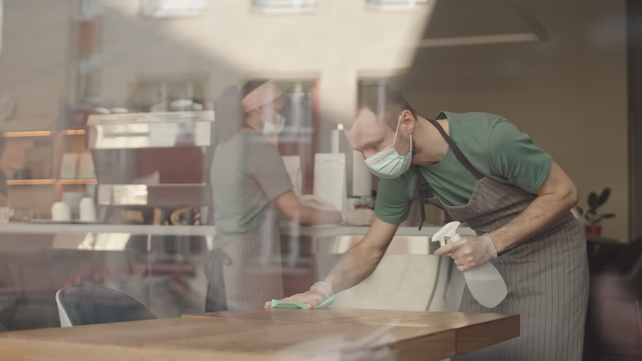 Wait Staff Cleaning Tables in Restaurant