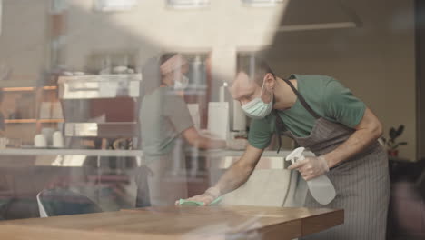 wait staff cleaning tables in restaurant