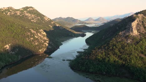 Quiet-tripod-shot-of-evening-atmosphere-at-idyllic-river-delta-in-Rijeka-Crnojevica,-Montenegro