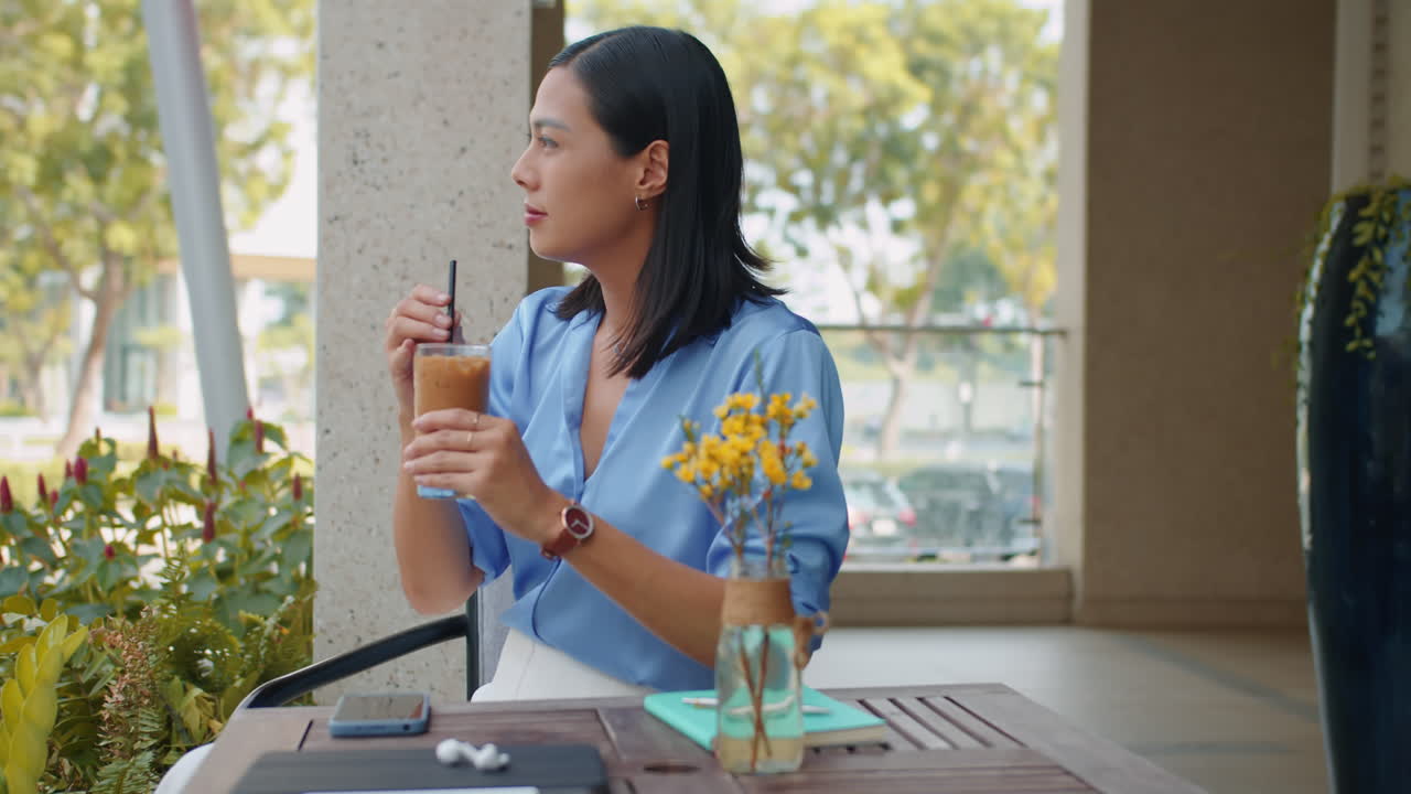 Elegant Businesswoman Having Iced Coffee in Cafe