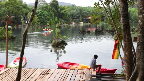 person prepares kayak on serene krabi waterway