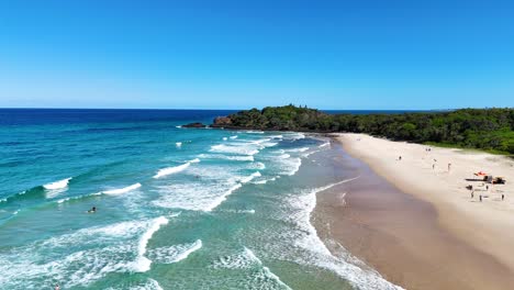 aerial view of beach with waves and people