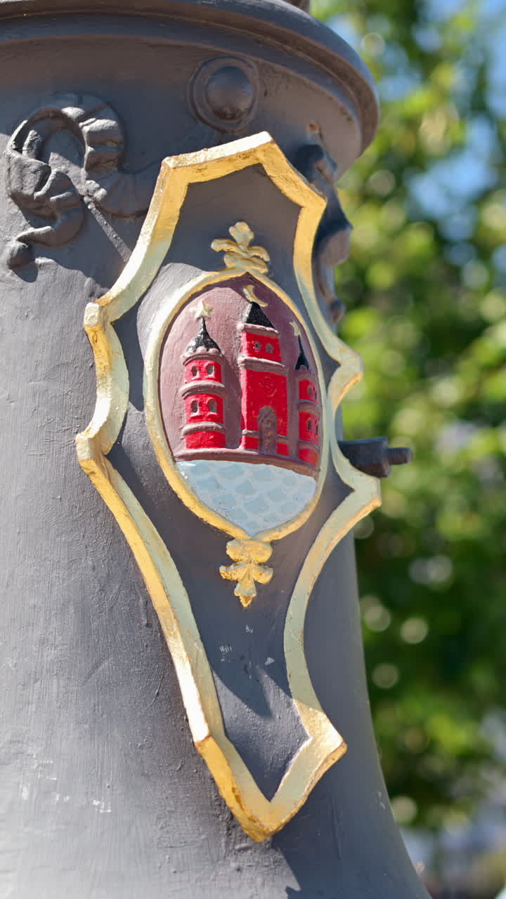 Detail view of a shield on a street lamp in Copenhagen, Denmark. Vertical