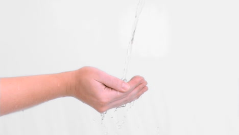 water falling in super slow motion on hands