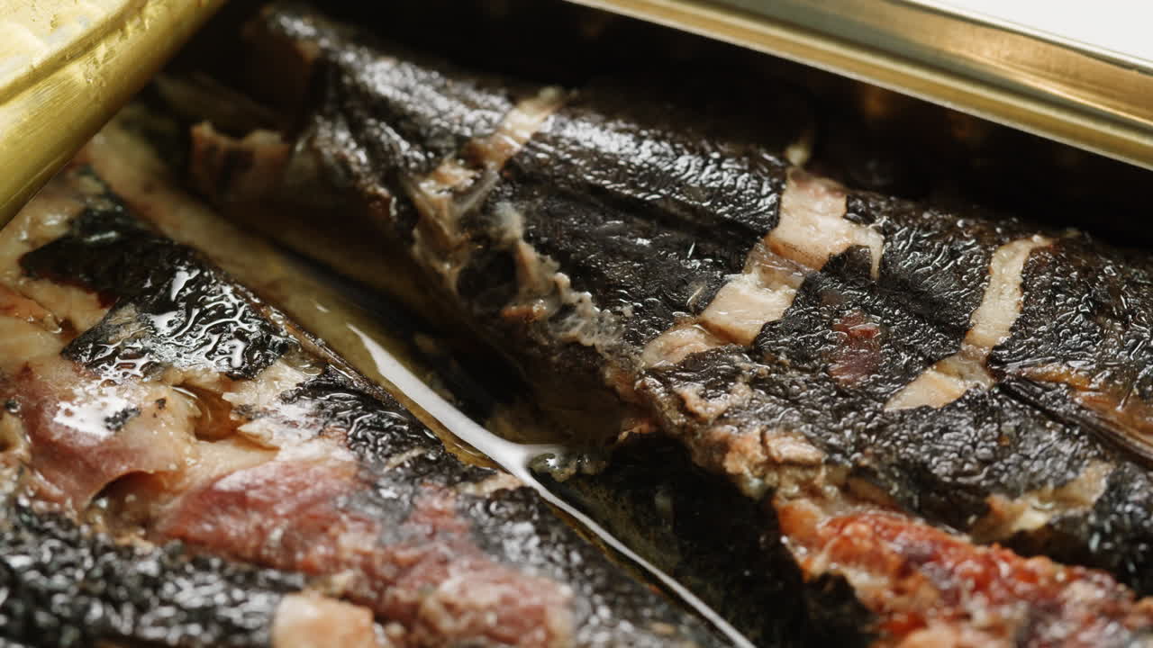 Delicately smoked fish fillets artfully presented in a beautifully designed tin, ideal for gourmet culinary inspiration