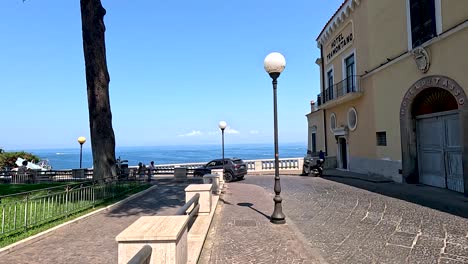 couple walking along seaside street in naples