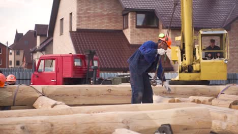 log house construction with crane