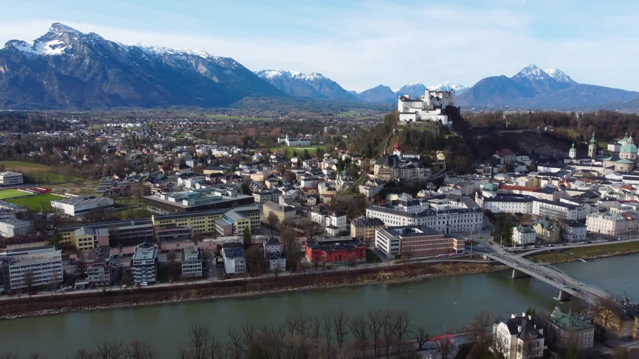 Salzburg Fortress sat atop city with snow-topped Salzkammergut Mountains - Austria