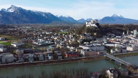 salzburg fortress sat atop city with snow-topped salzkammergut mountains - austria