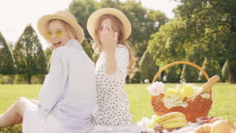 two friends enjoying a picnic in the park