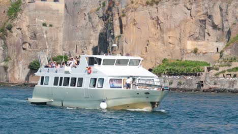 passenger ship cruising near rocky naples coastline