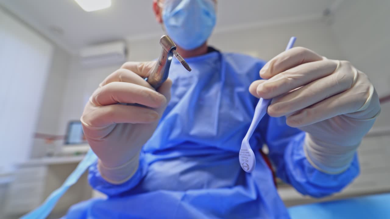 Hands holding dental tools. Hand of dentist holding tool and dental drill machine