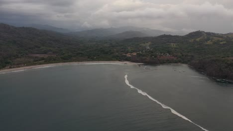 Playa-Carrillo-Beach-in-Costa-Rica-Pacific-coastline-with-half-moon-beach,-Aerial-dolly-in-shot