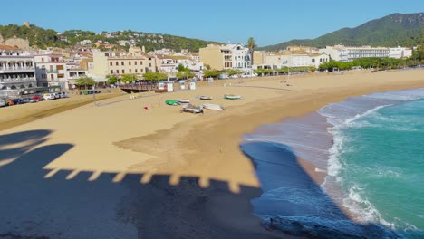 tossa de mar bay seen from the castle to the beach with coarse sand and turquoise blue sea water old walled medieval fishing village mediterranean sea