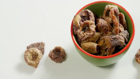 dried fig in bowl placed on white surface 4k 4k