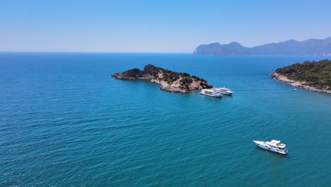 drone shooting endless sea with pleasure boats small islands and mountain ranges