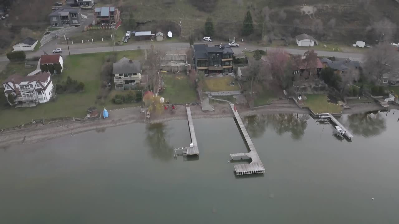 An aerial shot of a house looking over a lake