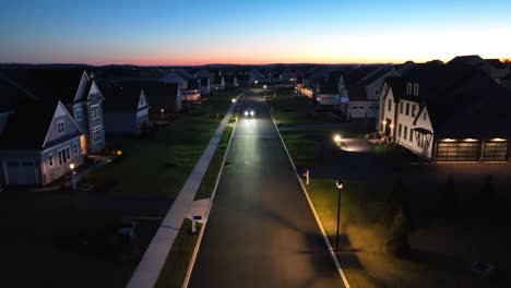 wealthy neighborhood in gated community with mansions in usa at night