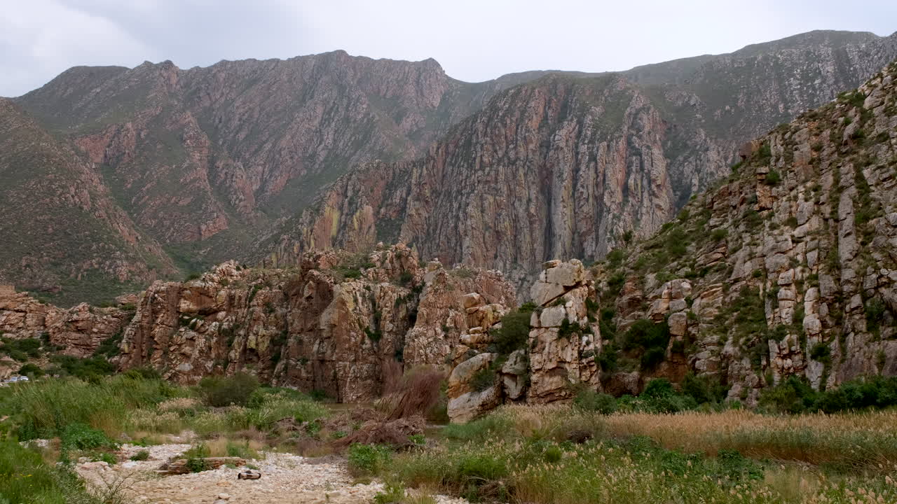 View over riverbed of jagged rocky mountainside of Langeberg Mountains