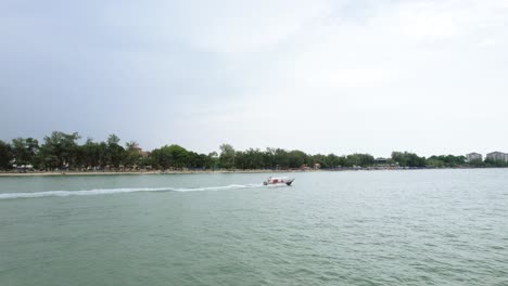 drone shot of a speedboat sailing near port dickson beach in malaysia