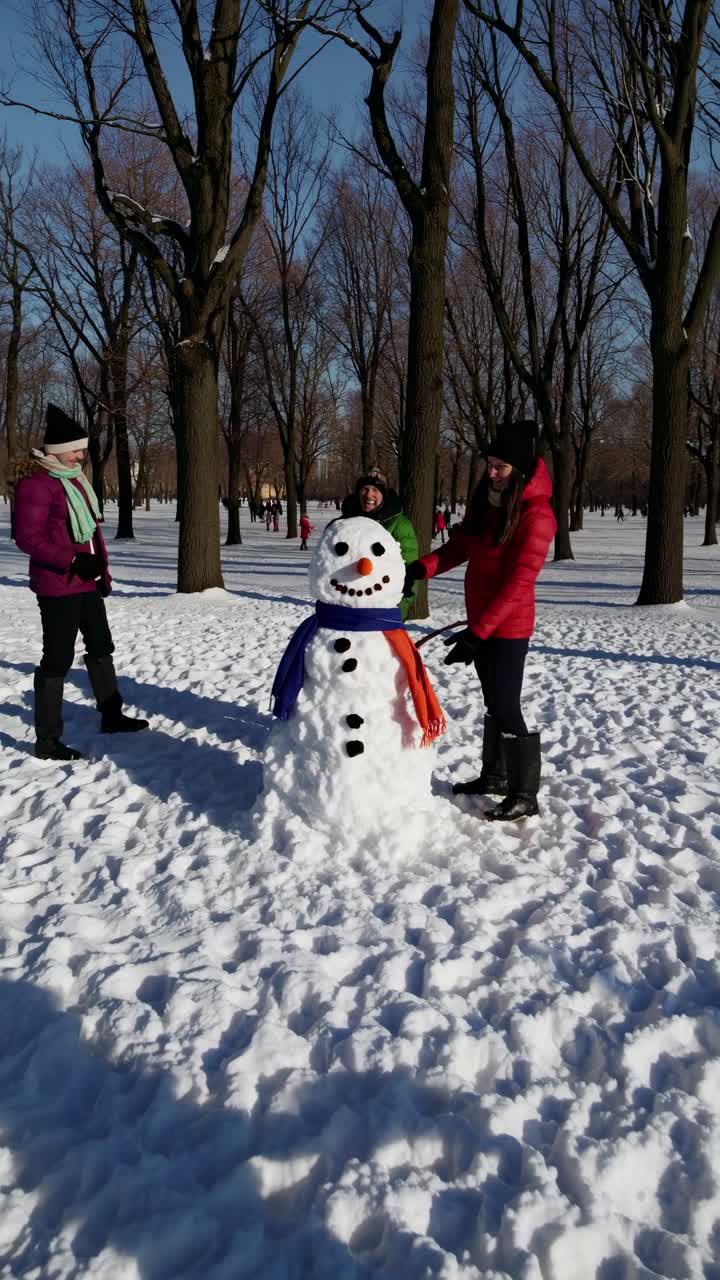 A joyful winter scene with friends building a snowman in a snowy park