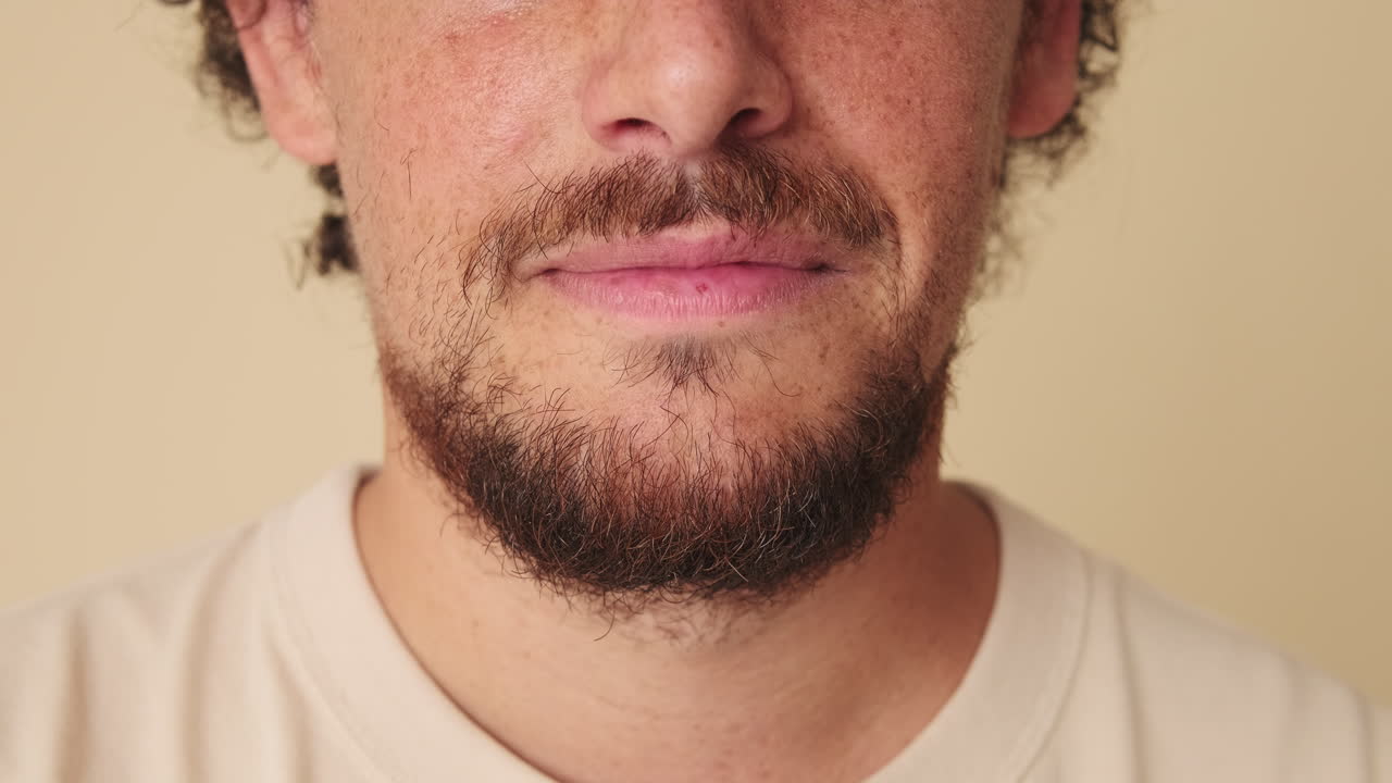 Close-up of a Man with a Beard Slowly Smiling