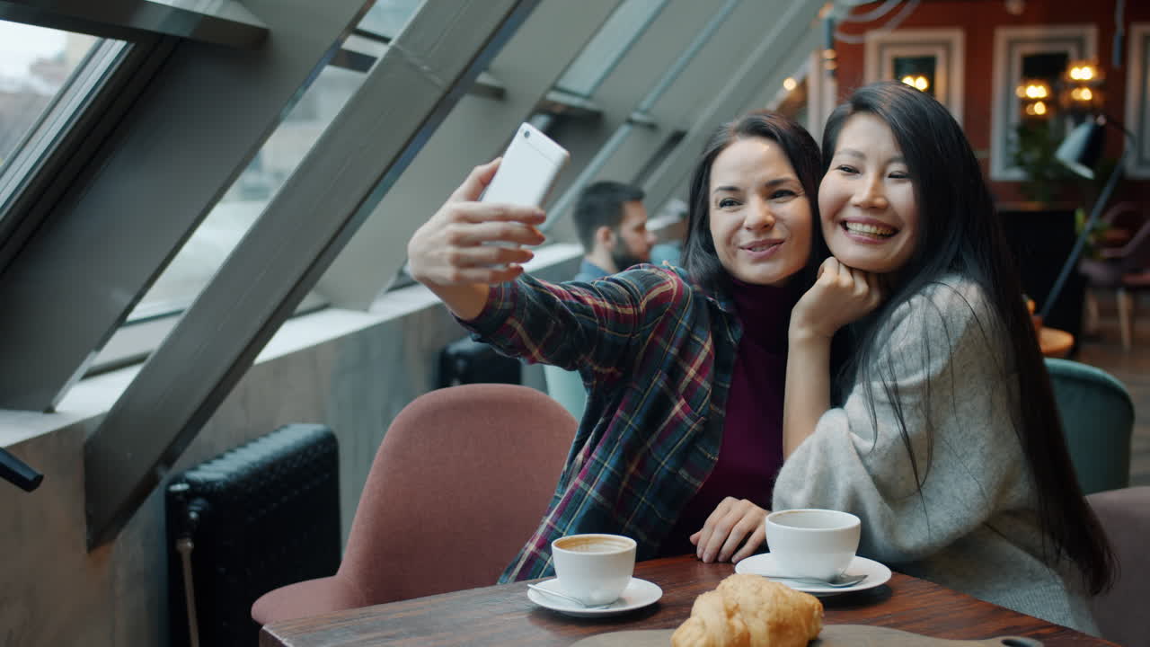 Friends taking a selfie in a cafe
