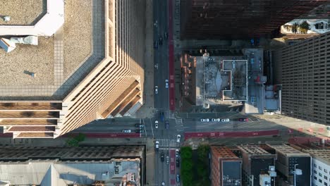 Top-down-aerial-above-traffic-in-downtown-urban-city-in-USA