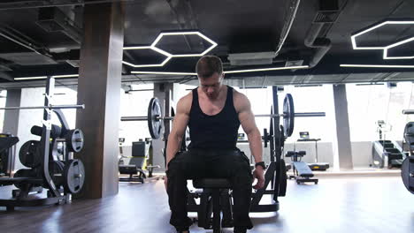 man workout in indoor gym. muscular bodybuilder handsome man doing exercises in gym