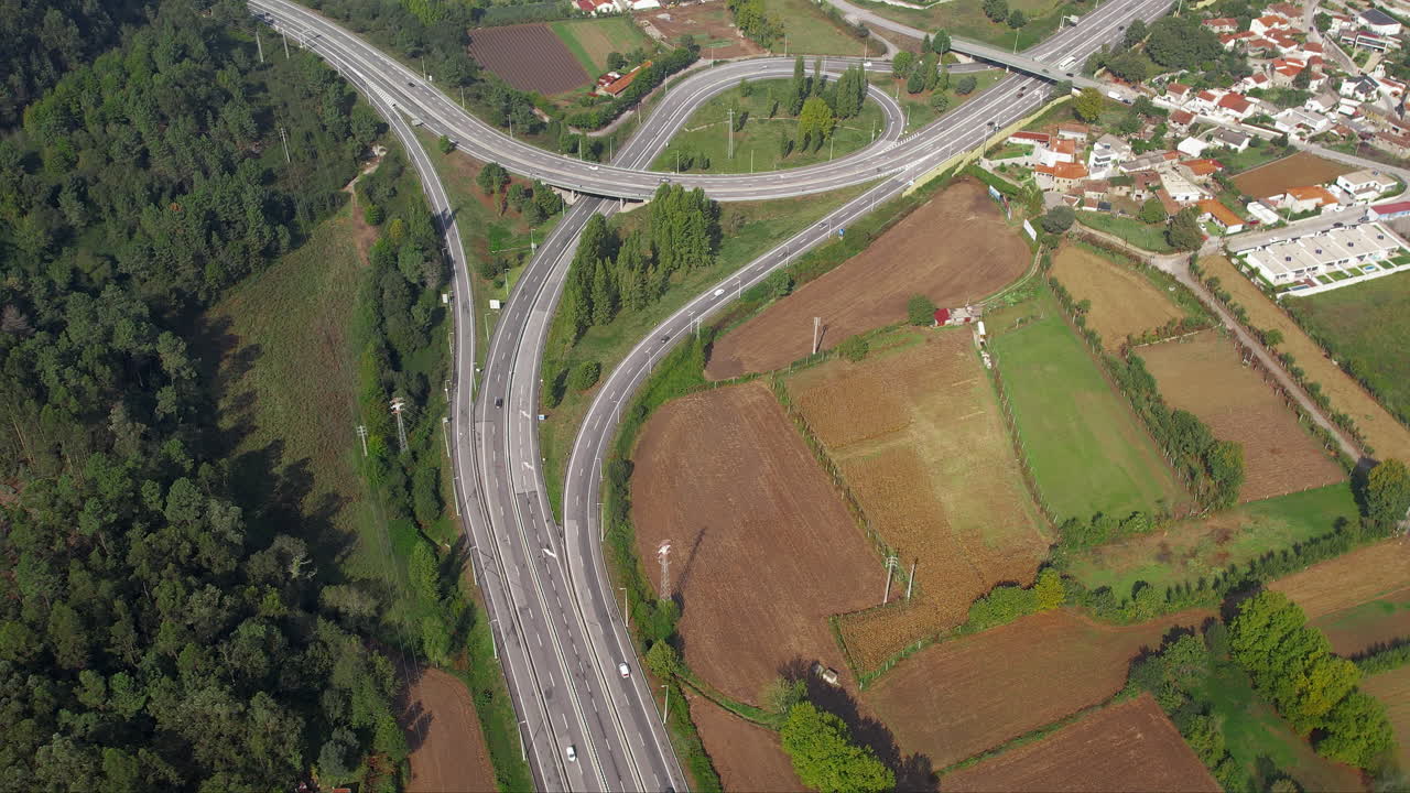 Aerial shot of Portugal's highway amidst farmland and forested areas